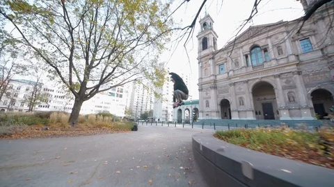 Man doing 180 jump on inline skates from parapet Stock Footage 120445698