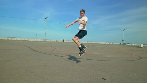 Man doing 360 jump on skates Stock Footage 125317672