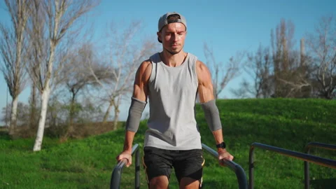 Man doing abs exercises on parallel bars Stock Footage 234885493