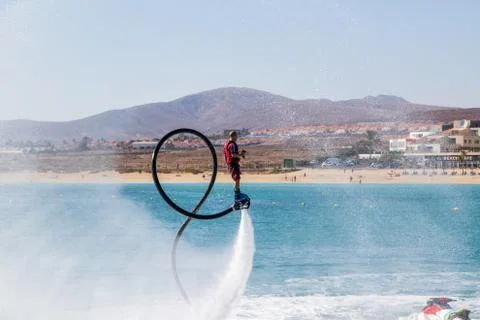 A man doing acrobatics with flyboard Stock Photos