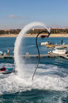 A man is doing acrobatics with flyboard Stock Photos