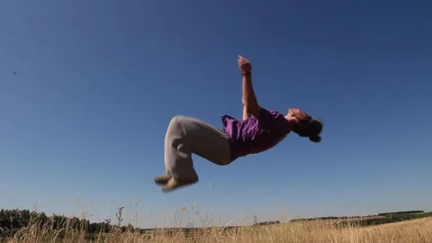 Man doing back flip in the field Stock Footage 158012252