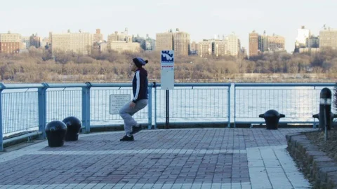 Man doing back flip at promenade Stock Footage 99753677