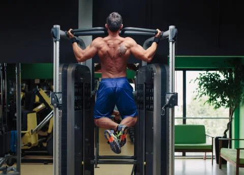 Man doing back training in the gym Stock Photos