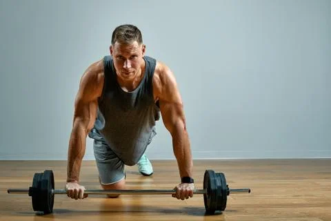 Man doing back workout, barbell row in studio over gray background. Copy space Foto stock