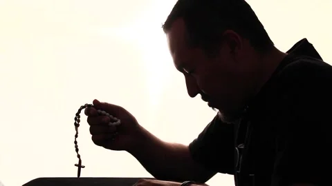 Man doing backlight prayer Stock Footage 136065011