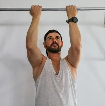 Man doing barbell exercises for the back at the gym. Stock Photos