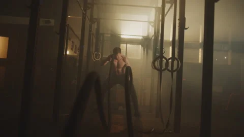 Man doing battle rope workout Stock Footage 236184562