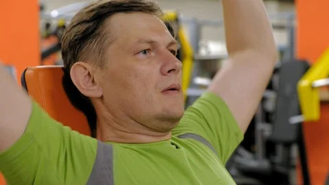A man doing a bench press with dumbbells sitting with a straight grip in a Video stock 111507280