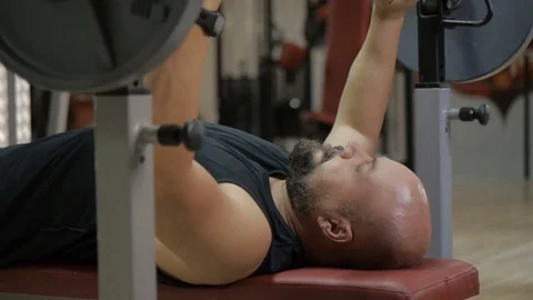 Man doing bench press in gym 動画素材 79538989