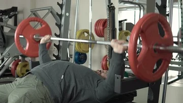 Man doing a bench press in the gym close-up 4k. Stock Footage 85587678