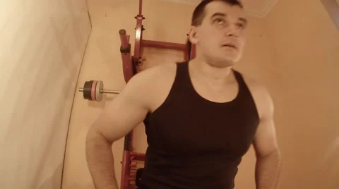 Man Doing a Bench Press Using a Barbell in the Room Stock Footage 62475435