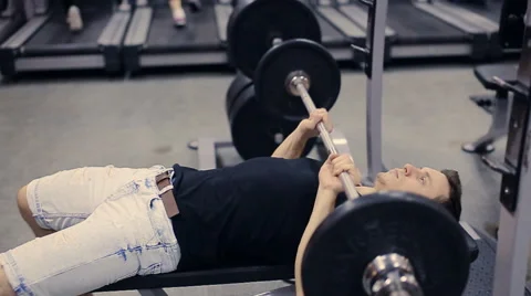 Man doing bench press workout in gym 스톡 동영상 58565956
