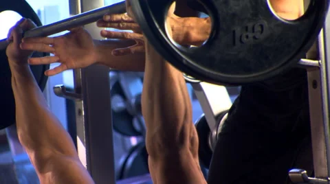 Man doing bench presses in a gym with spotter assisting Vídeos de archivo 59515881