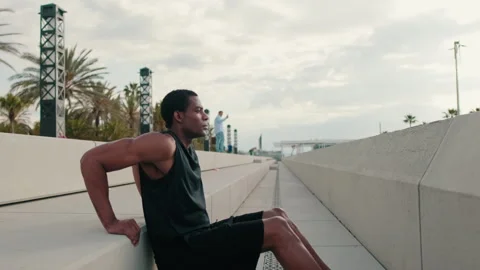 Man Doing Bench Tricep Dips Exercise by the Beach Stock Footage 316578339