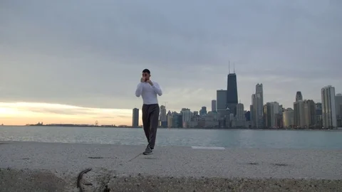 Man is doing boxing exercises on ebankment. Athlete is training outdoors Stock-Footage 82638443