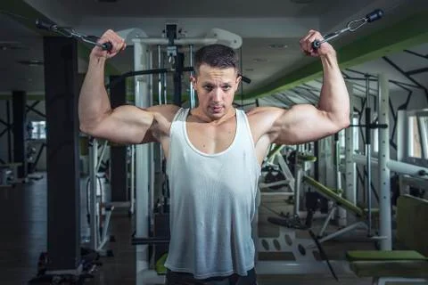 Man doing cable fly exercise in gym Stock Photos