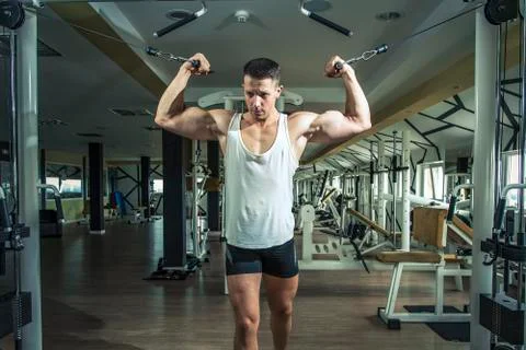 Man doing cable fly exercise in gym Stock Photos
