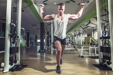 Man doing cable fly exercise in gym Stock Photos