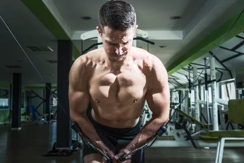 Man doing cable fly exercise in gym Stock Photos