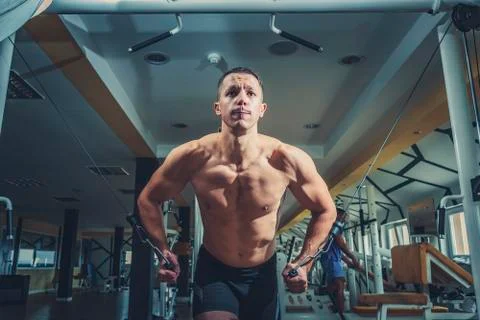 Man doing cable fly exercise in gym Stock Photos