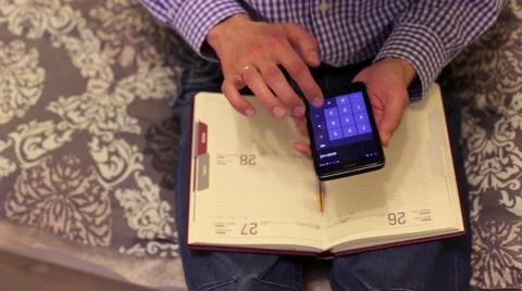 Man Doing Calculations on Phone Stock Footage 60005016