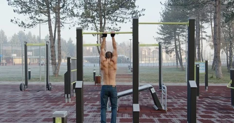 Man doing calisthenics exercise in the park Stock Footage 121715070