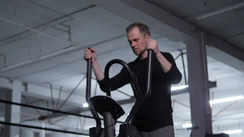 Man doing cardio workout on elliptical Stock Footage 312065901