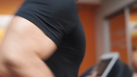 Man doing cardio workout on the treadmill. Close up bicep curl shot 動画素材 123149955