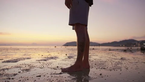 Man doing cartwheel on the beach at sunset Stock-Footage 74779216