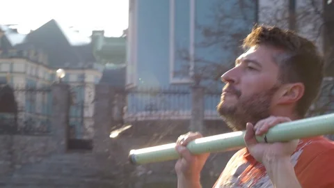 Man doing chest and arms exercise with body bar outdoors Stock Footage 127033830