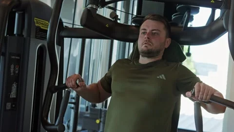 Man doing chest press on a machine 스톡 동영상 339598852