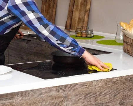 A man doing the cleaning in the modern kitchen, close-up, hand and rag Stock Photos