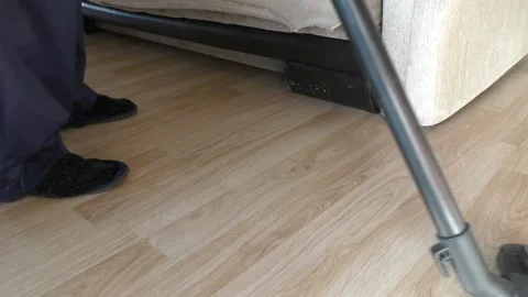 A man doing cleaning with a vacuum cleaner Stock Footage 167439612