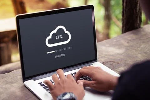 Man doing cloud uploading on laptop / computer at the park / outdoor Stock Photos