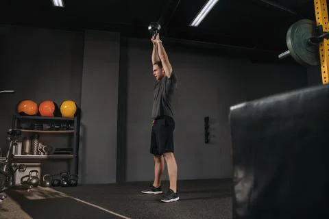 Man doing crossfit training with kettlebell at gym Stock Photos
