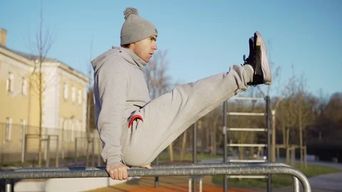 Man doing dips and l-sits on parallel bars Stock Footage 129556067
