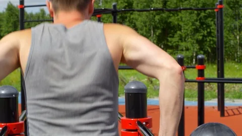 Man Doing Dips on Parallel Bars Outdoor 動画素材 97637841