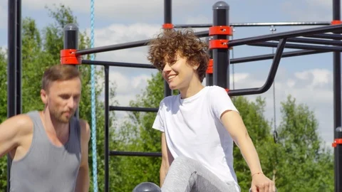 Man Doing Dips on Parallel Bars and Talking with Wife Video stock 97638068