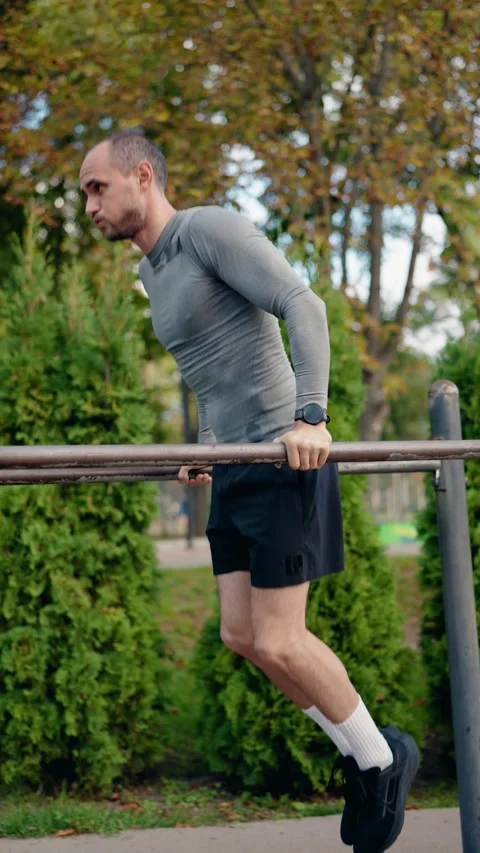 Man Doing Dips on Parallel Bars in a Park 스톡 동영상 310683345
