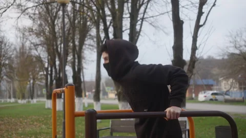 Man Doing Dips on Parallel Bars at Outdoor Workout Park Stock Footage 326924975