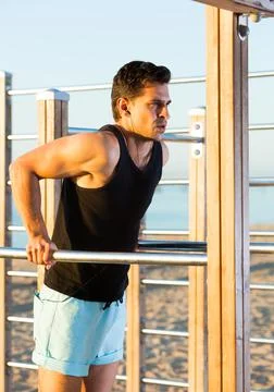 Man doing dips on parallel bars Stock Photos