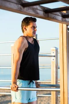 Man doing dips on parallel bars 写真素材