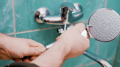 Man doing DIY plumbing repairs in his bathroom. The homeowner is replacing an ol Stock Footage 339798852