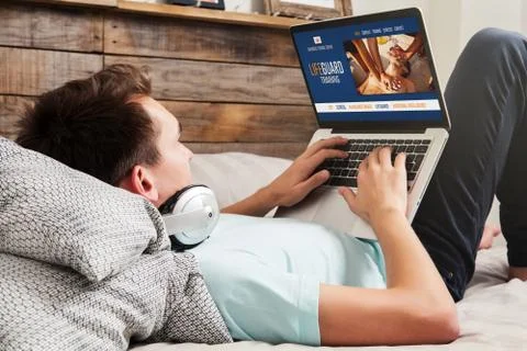 Man doing an e-learning lifeguard training by internet with a laptop computer Stock Photos