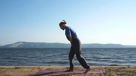 Man doing equilibration exercise at the beach Stock Footage 80658315