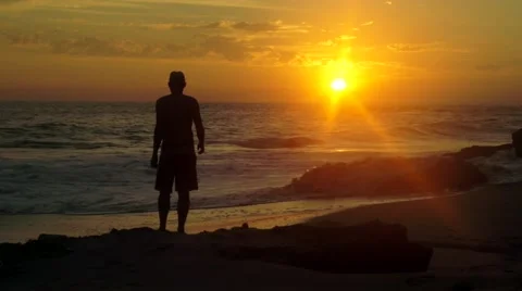 Man doing exercise on the beach in front of beautiful sunset Stock Footage 46081355