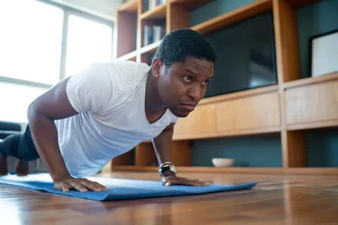 Man doing exercise at home. Stock Photos