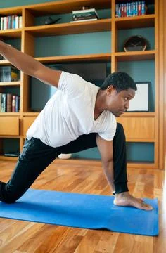 Man doing exercise at home. Stock Photos