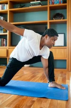 Man doing exercise at home. Stock Photos